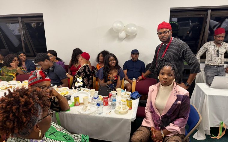 Igbo Union Northamptonshire - Members seated at decorated tables in a hall during a community gathering
